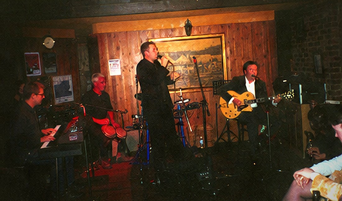 The band across a small stage with an organ at the left.